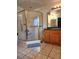 Bright bathroom with a walk-in shower with seating, tile floors, and a vanity at 17051 Ne 243Rd Place Rd, Fort Mc Coy, FL 32134