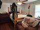 Spacious bedroom with four-poster bed, ceiling fan, wood floors and lots of natural light at 17051 Ne 243Rd Place Rd, Fort Mc Coy, FL 32134