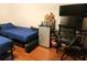 Cozy bedroom featuring twin beds, study space, and wood-look flooring at 17051 Ne 243Rd Place Rd, Fort Mc Coy, FL 32134