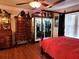Bedroom with hardwood floors, canopy bed, and vintage wood furniture at 17051 Ne 243Rd Place Rd, Fort Mc Coy, FL 32134