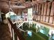 Interior view of a boathouse with boat lifts and wooden structure reflecting in the water at 17051 Ne 243Rd Place Rd, Fort Mc Coy, FL 32134