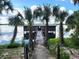 Charming boat house with palm trees and a wooden walkway to the lake at 17051 Ne 243Rd Place Rd, Fort Mc Coy, FL 32134