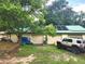 View of 3-car garage featuring solar panels and a vehicle parked in the driveway at 17051 Ne 243Rd Place Rd, Fort Mc Coy, FL 32134