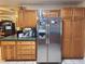 Kitchen featuring wood cabinets, stainless steel refrigerator, and green countertops at 17051 Ne 243Rd Place Rd, Fort Mc Coy, FL 32134