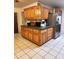 Kitchen with wood cabinets, stainless steel refrigerator, and ample counter space at 17051 Ne 243Rd Place Rd, Fort Mc Coy, FL 32134