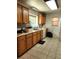 Bright kitchen featuring wood cabinets, white appliances, and ample counter space at 17051 Ne 243Rd Place Rd, Fort Mc Coy, FL 32134