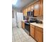 Traditional style kitchen featuring stainless steel appliances, tile floors, and wood cabinetry at 17051 Ne 243Rd Place Rd, Fort Mc Coy, FL 32134