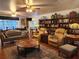 Comfortable living room with ample seating, a built-in bookcase, and an area rug at 17051 Ne 243Rd Place Rd, Fort Mc Coy, FL 32134