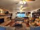 Cozy living room featuring a stone fireplace, hardwood floors, and built-in bookshelves at 17051 Ne 243Rd Place Rd, Fort Mc Coy, FL 32134