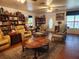 Spacious living room with wood floors, plush seating, and plenty of natural light at 17051 Ne 243Rd Place Rd, Fort Mc Coy, FL 32134