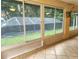View of a screened-in pool area from inside the sunroom, offering a relaxing retreat at 17051 Ne 243Rd Place Rd, Fort Mc Coy, FL 32134