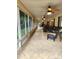 Spacious sunroom with tile flooring, ceiling fans, and windowed walls overlooking the yard at 17051 Ne 243Rd Place Rd, Fort Mc Coy, FL 32134