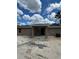 The back of the house features a covered patio area, perfect for outdoor relaxation and entertaining, under a partly cloudy sky at 21712 Sw Rainbow Lakes Blvd, Dunnellon, FL 34431