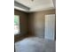 Unfinished bedroom with a tray ceiling and a window providing natural light, awaiting personalization and final touches at 21712 Sw Rainbow Lakes Blvd, Dunnellon, FL 34431