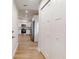 Hallway featuring closet leading to a modern kitchen with stainless steel appliances and light wood flooring at 2264 Sw Moines Ct, Dunnellon, FL 34431