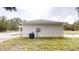 Side exterior of a single-story home with neutral siding, showing the electrical and air conditioning units at 23995 Nw Falcon Ave, Dunnellon, FL 34431