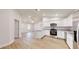 Spacious living area flows into the kitchen with its modern white cabinets and appliances at 23995 Nw Falcon Ave, Dunnellon, FL 34431