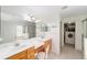 Bright bathroom features a double sink vanity with a large mirror and a walk-in closet at 2413 Se 23Rd St, Ocala, FL 34471