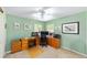 This bedroom features green walls, ceiling fan, and a desk area with computer and printer setup at 2413 Se 23Rd St, Ocala, FL 34471