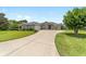 Charming single story home with a large driveway and well-manicured lawn and mature landscaping at 2413 Se 23Rd St, Ocala, FL 34471