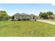 Well-manicured front yard with mature landscaping, bushes and plants, complimenting this single story home at 2413 Se 23Rd St, Ocala, FL 34471