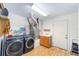 Well-equipped laundry room featuring a washer and dryer, sink, and built-in storage shelves at 2413 Se 23Rd St, Ocala, FL 34471