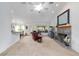 Open concept living room featuring a fireplace, lots of seating, and views to the outside at 2413 Se 23Rd St, Ocala, FL 34471