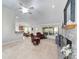 Spacious living room with fireplace, lots of seating, and view of the kitchen and backyard at 2413 Se 23Rd St, Ocala, FL 34471