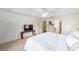 A spacious main bedroom showcases a tray ceiling, neutral carpeting, and a simple decor setup at 2413 Se 23Rd St, Ocala, FL 34471