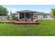 Back patio features plenty of room for seating among plants and other decorations overlooking backyard at 2413 Se 23Rd St, Ocala, FL 34471