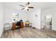 Bright bedroom with a wooden desk, a comfortable chair, and hardwood flooring at 2552 Ne 42Nd Rd, Ocala, FL 34470