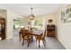 Comfortable dining room featuring a wooden table and chairs with great lighting and backyard views at 2552 Ne 42Nd Rd, Ocala, FL 34470