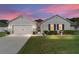 Charming single-Gathering home featuring manicured lawn, and attached two-car garage, inviting curb appeal at 2552 Ne 42Nd Rd, Ocala, FL 34470