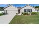 Charming single-Gathering home with an inviting front yard and well-maintained landscaping under a clear blue sky at 2552 Ne 42Nd Rd, Ocala, FL 34470
