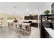 Bright kitchen featuring dark cabinets, stainless steel appliances, and a large island with seating, offering ample space at 2552 Ne 42Nd Rd, Ocala, FL 34470