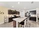 Modern kitchen with dark cabinetry, large island with seating, and stainless steel appliances offers an open layout at 2552 Ne 42Nd Rd, Ocala, FL 34470
