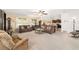 Spacious living room with abundant natural light and two large couches. Includes ceiling fan and neutral walls at 2552 Ne 42Nd Rd, Ocala, FL 34470