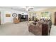 Spacious carpeted living room with large windows and comfortable seating, perfect for relaxation and entertainment at 2552 Ne 42Nd Rd, Ocala, FL 34470