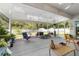Spacious screened patio with diverse seating options and views of the lush backyard at 2552 Ne 42Nd Rd, Ocala, FL 34470