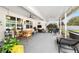 Relaxing screened patio features comfortable seating and a view of the manicured backyard at 2552 Ne 42Nd Rd, Ocala, FL 34470