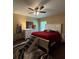 Cozy bedroom featuring a comfortable bed, dresser, and a ceiling fan for added comfort at 3545 Se 24Th Ave, Ocala, FL 34471