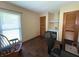 Bedroom features hardwood floors, built-in desk, and natural light from the large window at 3545 Se 24Th Ave, Ocala, FL 34471