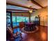 Dining room featuring hardwood floors, wood beams, a ceiling fan and natural light from windows at 3545 Se 24Th Ave, Ocala, FL 34471
