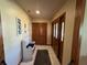 Inviting entryway with tiled floor, wood accents, a storage bench and closet for added convenience at 3545 Se 24Th Ave, Ocala, FL 34471