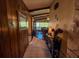 Hallway featuring tile flooring and wood paneling leading to the dining room, enhancing the home's charm at 3545 Se 24Th Ave, Ocala, FL 34471