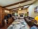 Inviting living room featuring a stone fireplace, wood beams, and stylish decor at 3545 Se 24Th Ave, Ocala, FL 34471