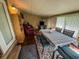 Bright sun room with dining set and comfortable armchair, filled with natural light at 3545 Se 24Th Ave, Ocala, FL 34471