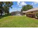Lush backyard with screened pool enclosure and verdant lawn creating a serene outdoor retreat for relaxation and enjoyment at 4300 Nw 4Th Cir, Ocala, FL 34475