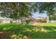 Inviting backyard with a screened pool and lush lawn, framed by mature trees, perfect for relaxation and outdoor activities at 4300 Nw 4Th Cir, Ocala, FL 34475