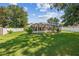 Picturesque backyard featuring a screened-in pool, complemented by a well-manicured lawn, creating an ideal outdoor living space at 4300 Nw 4Th Cir, Ocala, FL 34475
